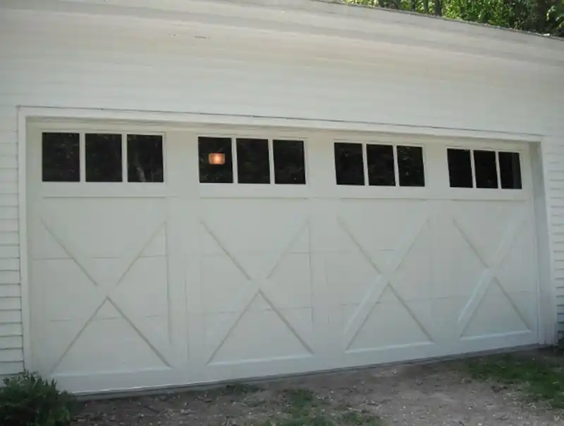 One wide cream X-brace door with a top window row and dark windows