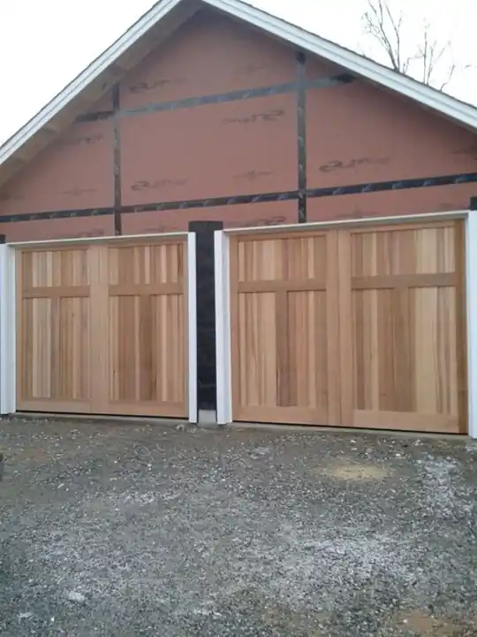 Two doors during installation, with house wrap and trim still bare