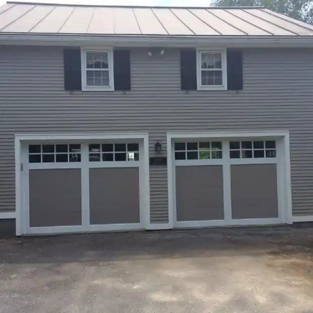 Two windowed panel doors, taupe with white trim, on grey siding