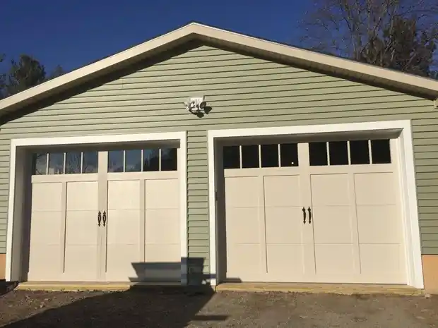 Two cream windowed doors on a green house