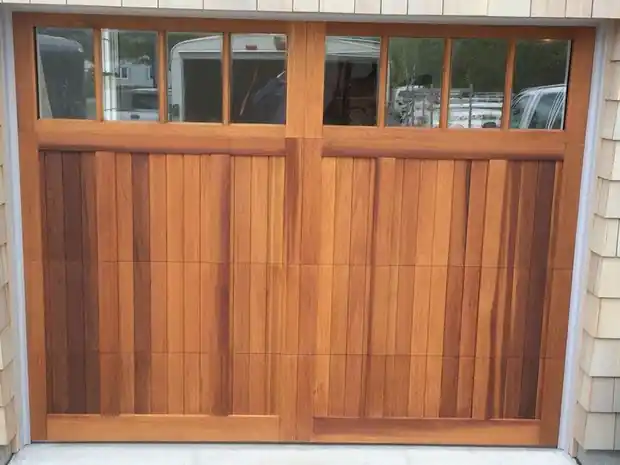 Close view of a dark door with a window row