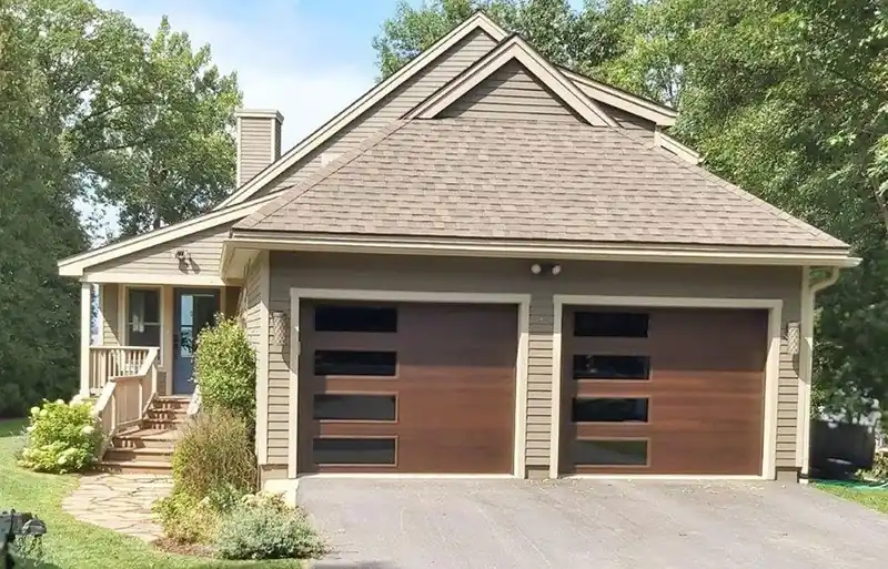 Two dark doors with narrow horizontal windows on a shingled house, stone path